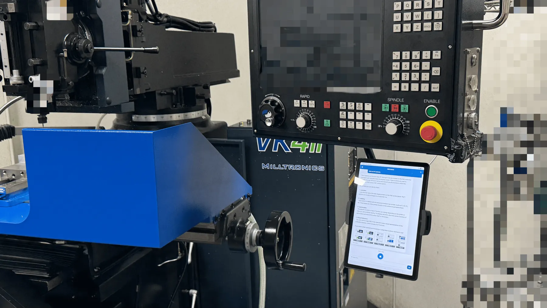 The interface sits right at the machine — a simple screen with one button and an input field. Input and output by text or voice; the answer carries schematics and pointers to specific manual pages.