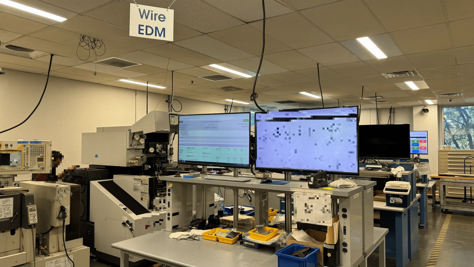 System demonstration on the shop floor — the UI is visible on the left screen, while the drawing is displayed on the right (blurred)